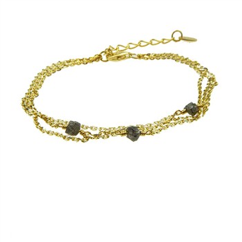 Gold bracelet with three chains, dark rough-cut stones, and an adjustable clasp closure.