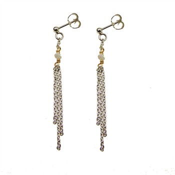 Elegant dangle earrings with silver and gold tones, cascading chains, and raw diamond accents.