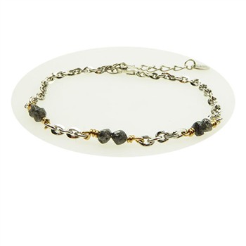 Silver and gold chain bracelet with dark stones and adjustable extension chain.