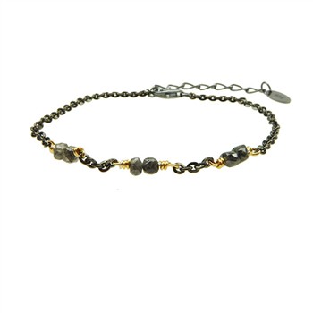 Black chain bracelet with gold links, raw diamonds, and adjustable extension against white background.