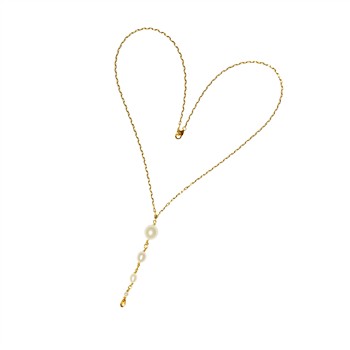 Gold Y-shaped necklace in heart shape with white pearls and clasp on white background.