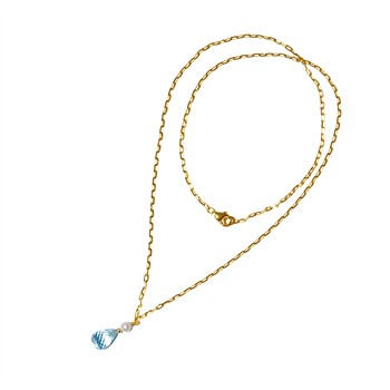 Gold chain necklace with blue teardrop gemstone and white pearl on a white background.