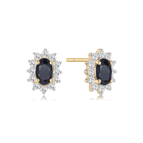 Gold earrings with central dark oval stone, clear halo stones, and post backing from Støvring Design.