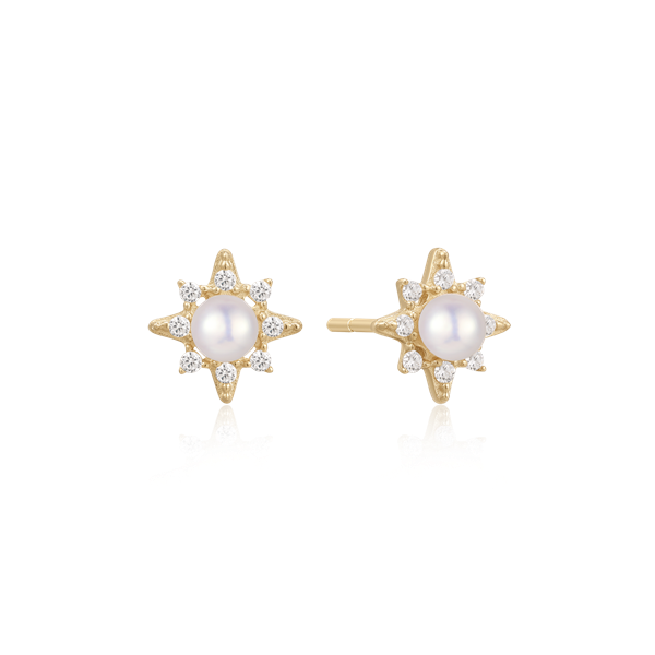 Star-shaped gold earrings with central pearl and diamond-like stones from Støvring Design.