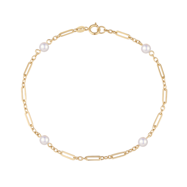 Gold bracelet with chain links, four white beads, and a clasp for fastening.