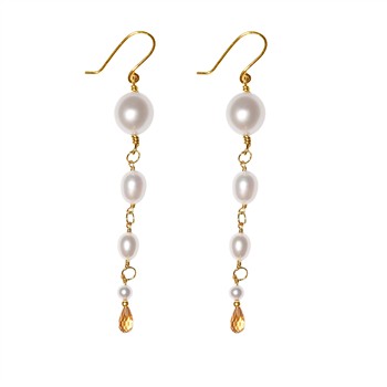 Gold earrings with vertical pearls and amber teardrop crystals.