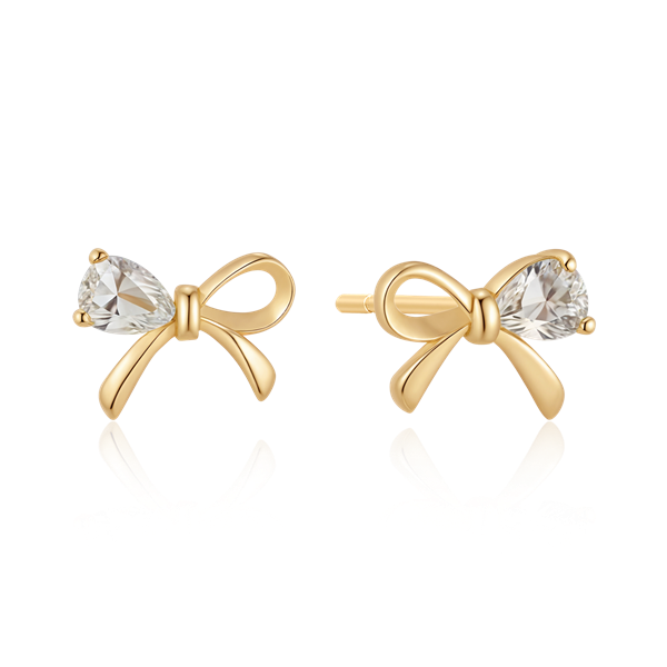 Bow-shaped gold earrings with clear teardrop stones, reflective finish, by Støvring Design.