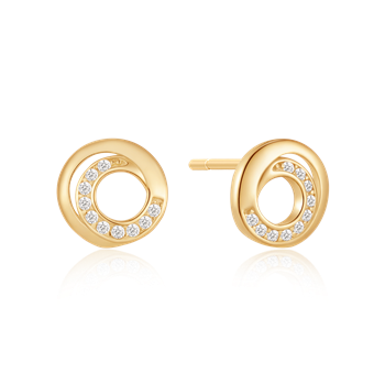 Gold circular stud earrings with embedded clear stones, reflecting light on a black background.