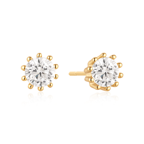 Gold-colored stud earrings with round stones, held by multiple prongs, polished finish.