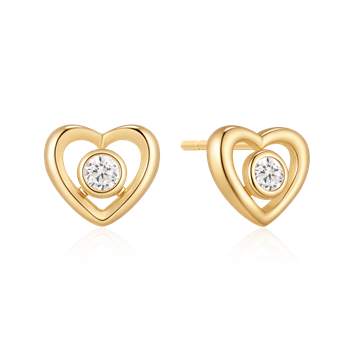 Heart-shaped gold earrings with central clear stone and polished finish.