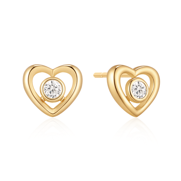 Heart-shaped gold earrings with central clear stone and polished finish.