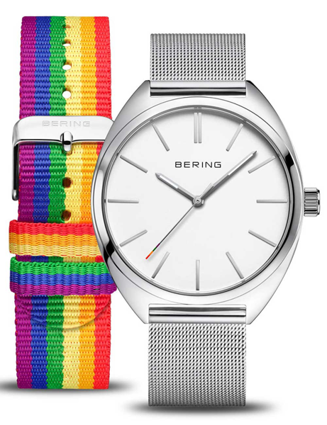Bering watch with white face, silver mesh band, and optional rainbow strap. Minimalist design.