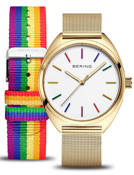 Gold-tone watch with a white dial, rainbow markers, and a fabric strap with "BERING" on the buckle.
