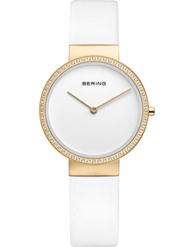 Bering ladies watch with a white strap, gold bezel with stones, and "BERING" on the white face.