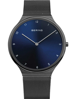 Minimalist Bering men's watch with deep blue dial, mesh band, and brand name "BERING" on the face.