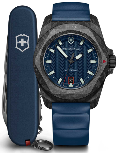Victorinox watch, blue textured dial, date at 6, blue strap, with a Swiss Army knife beside it.