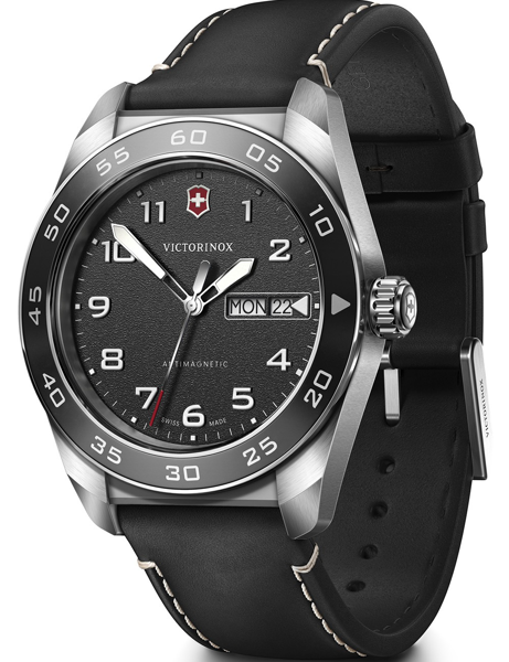 Black dial watch with silver markers, day-date display, antimagnetic label, black strap.
