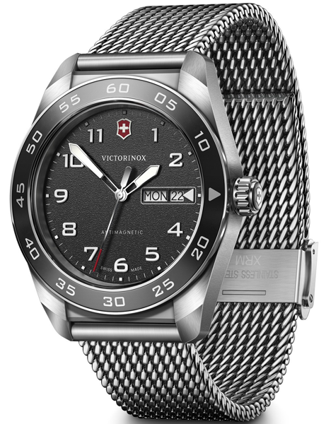 Black dial watch with white numerals, day-date display, metal mesh strap, and "ANTIMAGNETIC" text.
