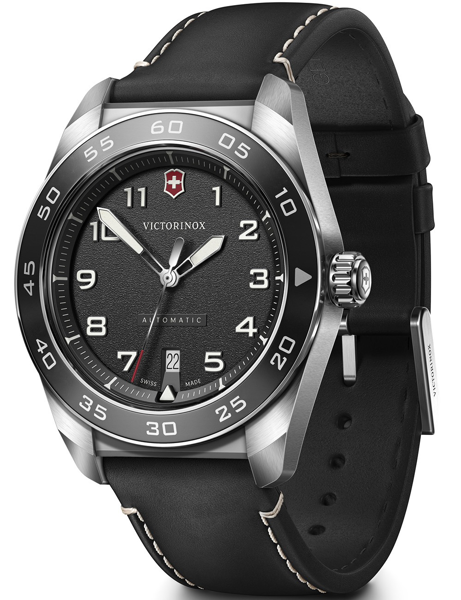 Black dial watch with white numerals, date at 6, black strap with stitching, and silver bezel.